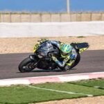 Moto de competencia Supersport 300 inclinando en curva durante carrera en circuito